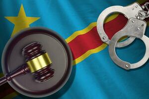 Democratic Republic of the Congo flag with judge mallet and handcuffs in dark room. Concept of criminal and punishment, background for judgement topics photo