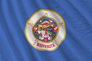 Minnesota US state flag with big folds waving close up under the studio light indoors. The official symbols and colors in banner photo