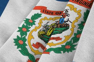 West Virginia US state flag with big folds waving close up under the studio light indoors. The official symbols and colors in banner photo