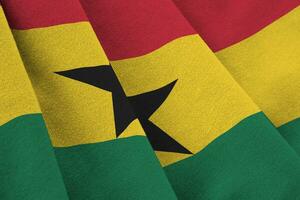 Ghana flag with big folds waving close up under the studio light indoors. The official symbols and colors in banner photo