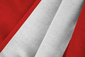 Peru flag with big folds waving close up under the studio light indoors. The official symbols and colors in banner photo