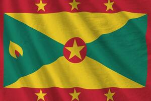 Grenada flag with big folds waving close up under the studio light indoors. The official symbols and colors in banner photo