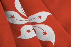 Hong kong flag with big folds waving close up under the studio light indoors. The official symbols and colors in banner photo