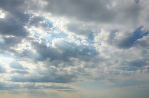 Blue sky background with white fluffy clouds in daytime outdoors photo