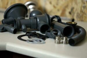 Tools and water tap ready for installation sink on countertop photo