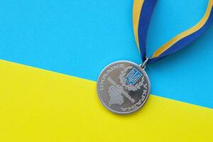 KYIV, UKRAINE - MAY 4, 2022 Medal for the person who conquered Mount Hoverla photo