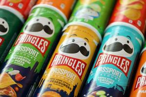 KYIV, UKRAINE - JULY 7, 2023 Pringles passport edition chips cans with different flavour photo