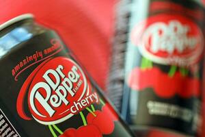 KYIV, UKRAINE - JULY 7, 2023 Dr Pepper cherry drink can on red background photo