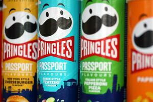 KYIV, UKRAINE - JULY 7, 2023 Pringles passport edition chips cans with different flavour photo