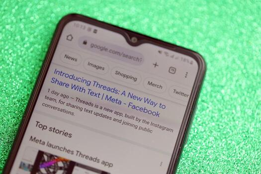 KYIV, UKRAINE - JULY 7, 2023 Threads by Meta application on display of Samsung smartphone lying on table photo