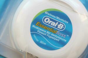 KYIV, UKRAINE - JULY 7, 2023 Oral-B Essentail Floss. Waxed dental floss in round case photo