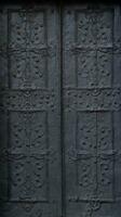 Old ancient metal door texture in european medieval style photo