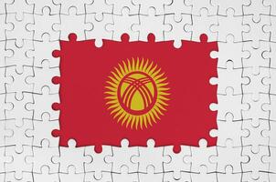 Kyrgyzstan flag in frame of white puzzle pieces with missing central part photo