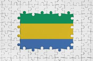Gabon flag in frame of white puzzle pieces with missing central part photo