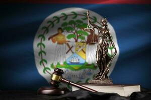 Belize flag with statue of lady justice, constitution and judge hammer on black drapery. Concept of judgement and guilt photo