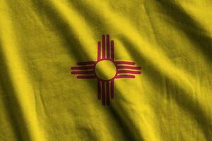 New Mexico US state flag with big folds waving close up under the studio light indoors. The official symbols and colors in banner photo