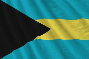 Bahamas flag with big folds waving close up under the studio light indoors. The official symbols and colors in banner photo