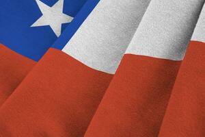 Chile flag with big folds waving close up under the studio light indoors. The official symbols and colors in banner photo