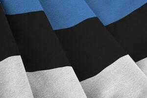 Estonia flag with big folds waving close up under the studio light indoors. The official symbols and colors in banner photo