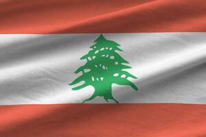 Lebanon flag with big folds waving close up under the studio light indoors. The official symbols and colors in banner photo