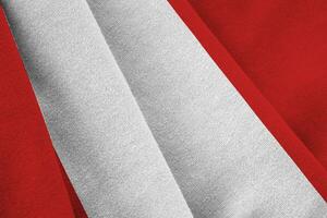 Peru flag with big folds waving close up under the studio light indoors. The official symbols and colors in banner photo