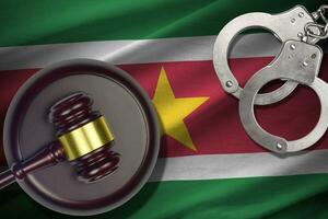 Suriname flag with judge mallet and handcuffs in dark room. Concept of criminal and punishment, background for judgement topics photo