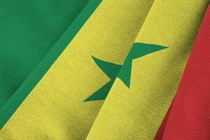 Senegal flag with big folds waving close up under the studio light indoors. The official symbols and colors in banner photo