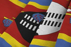 Swaziland flag with big folds waving close up under the studio light indoors. The official symbols and colors in banner photo