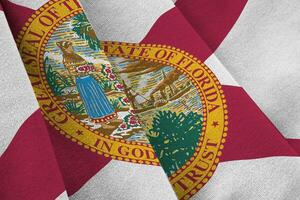 Florida US state flag with big folds waving close up under the studio light indoors. The official symbols and colors in banner photo