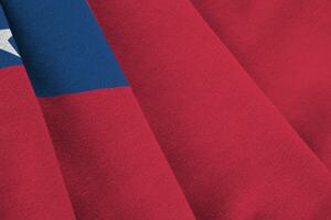 Samoa flag with big folds waving close up under the studio light indoors. The official symbols and colors in banner photo