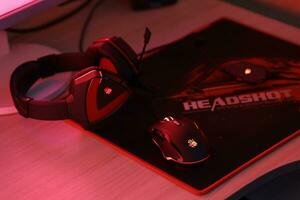 KYIV, UKRAINE - JULY 7, 2023 A4Tech Bloody G501 gaming headphones with microphone on table photo