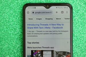 KYIV, UKRAINE - JULY 7, 2023 Threads by Meta application on display of Samsung smartphone lying on table photo