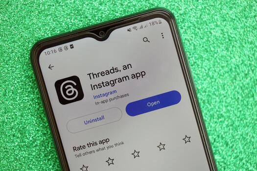 KYIV, UKRAINE - JULY 7, 2023 Threads by Meta application on display of Samsung smartphone lying on table photo