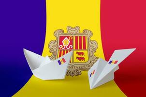 Andorra flag depicted on paper origami airplane and boat. Handmade arts concept photo