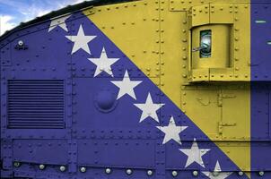 Bosnia and Herzegovina flag depicted on side part of military armored tank closeup. Army forces conceptual background photo