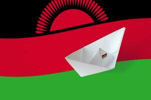 Malawi flag depicted on paper origami ship closeup. Handmade arts concept photo