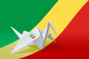 Congo flag depicted on paper origami crane wing. Handmade arts concept photo