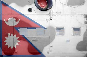 Nepal flag depicted on side part of military armored helicopter closeup. Army forces aircraft conceptual background photo