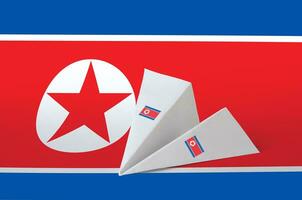 North Korea flag depicted on paper origami airplane. Handmade arts concept photo