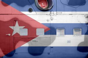 Cuba flag depicted on side part of military armored helicopter closeup. Army forces aircraft conceptual background photo