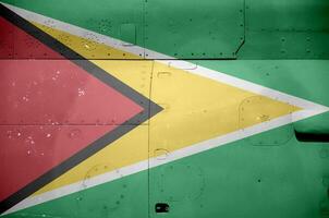 Guyana flag depicted on side part of military armored helicopter closeup. Army forces aircraft conceptual background photo