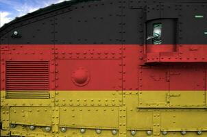 Germany flag depicted on side part of military armored tank closeup. Army forces conceptual background photo