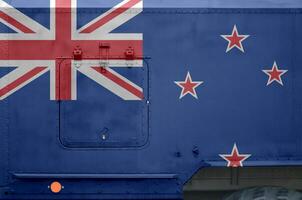 New Zealand flag depicted on side part of military armored truck closeup. Army forces conceptual background photo