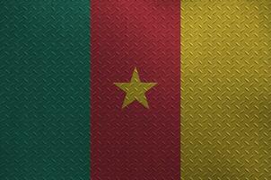 Cameroon flag depicted in paint colors on old brushed metal plate or wall closeup. Textured banner on rough background photo