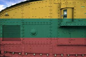 Lithuania flag depicted on side part of military armored tank closeup. Army forces conceptual background photo