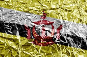 Brunei Darussalam flag depicted in paint colors on shiny crumpled aluminium foil closeup. Textured banner on rough background photo