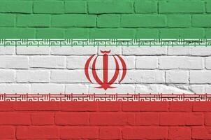 Iran flag depicted in paint colors on old brick wall. Textured banner on big brick wall masonry background photo