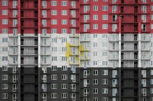 Egypt flag depicted in paint colors on multi-storey residental building under construction. Textured banner on brick wall background photo