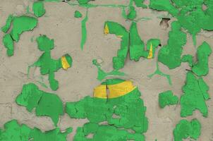 Mauritania flag depicted in paint colors on old obsolete messy concrete wall closeup. Textured banner on rough background photo