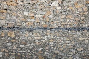 Texture of stone wall with many big brown stones photo